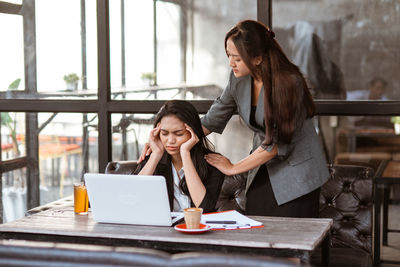 Young woman using mobile phone in cafe