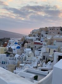 Townscape against sky at sunset