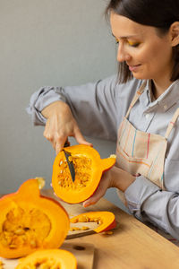 Young woman holding pumpkin