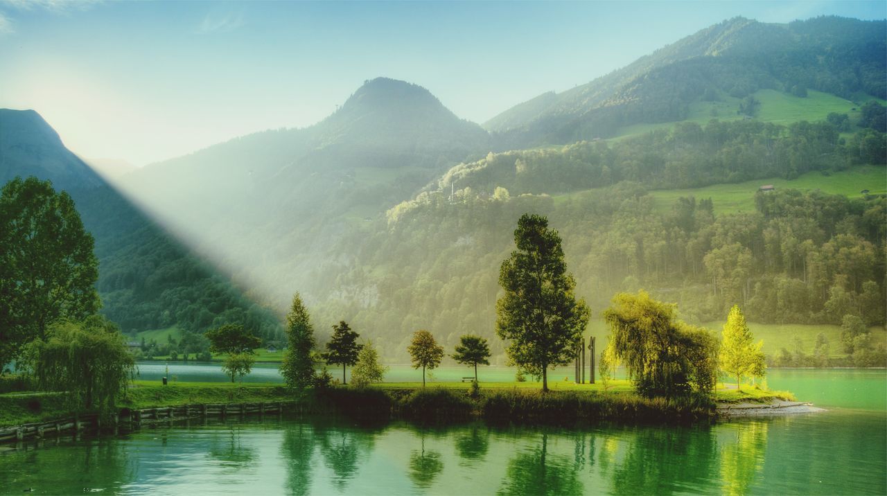 SCENIC VIEW OF LAKE WITH MOUNTAINS IN BACKGROUND