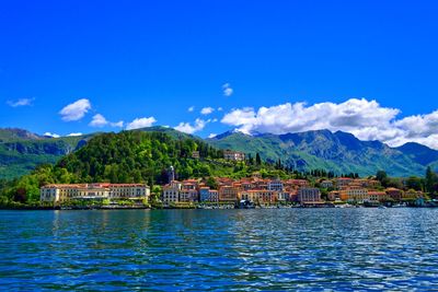 Scenic view of lake and mountains against blue sky