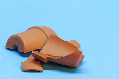 Close-up of chocolate cake on table against blue background