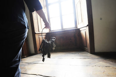 Low section of woman standing on floor at home