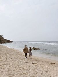 Rear view of women on beach