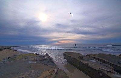 Scenic view of calm sea against cloudy sky