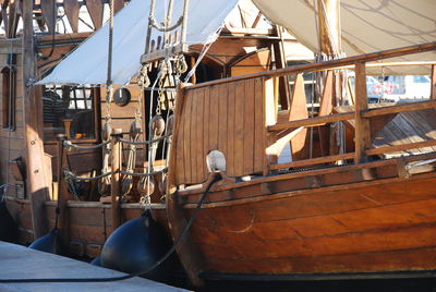 Sailboats moored at harbor