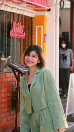 A picture of a happy woman while traveling in phuket old town.