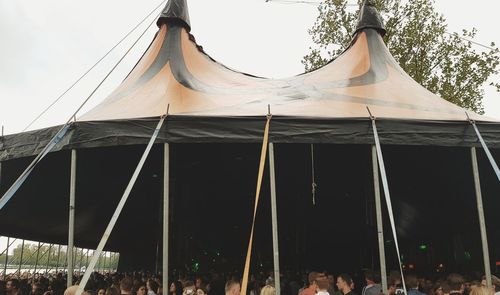 Low angle view of tent in building against sky