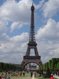 Eiffel tower against cloudy sky