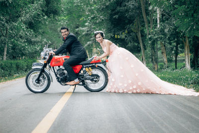 People riding motorcycle on road