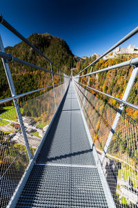 Footbridge against clear sky