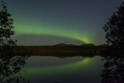 Scenic view of lake against sky at night