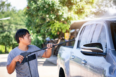 Rear view of boy standing in car