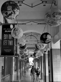 Men hanging in city against sky