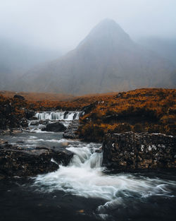 Scenic view of waterfall against sky