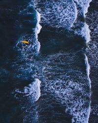 High angle view of water splashing on rocks