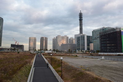 Modern buildings against cloudy sky