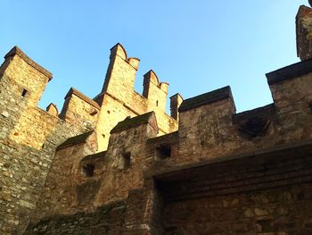 Low angle view of built structure against clear blue sky