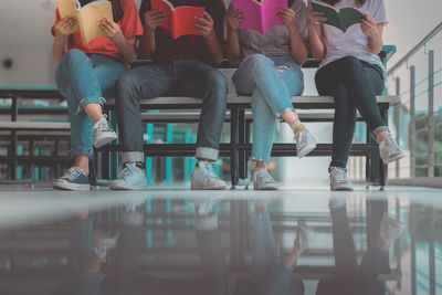 Low section of people sitting on seat