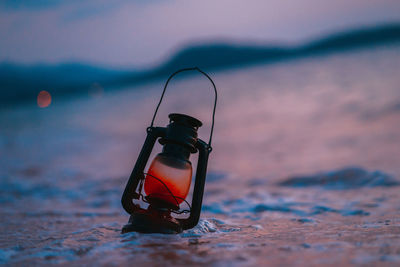 Close-up of illuminated electric light on beach