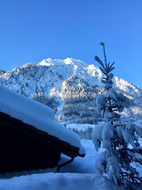 Snow covered mountain against clear blue sky