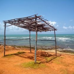 Lifeguard hut on beach against sky