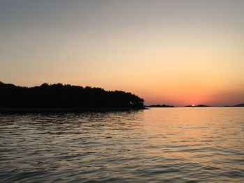 Scenic view of sea against orange sky