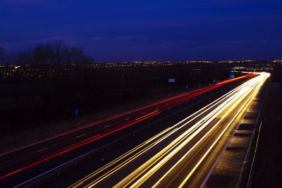 High angle view of light trails on road against sky