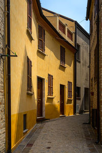 Alley amidst houses in town