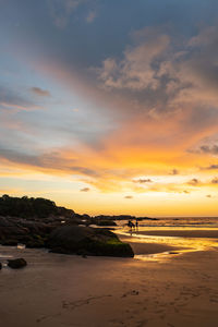 Scenic view of beach against sky during sunset