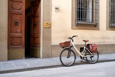 Bicycle parked against wall