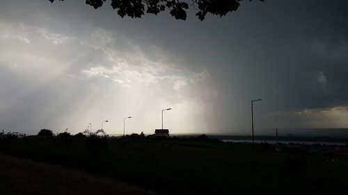 Silhouette of landscape against cloudy sky