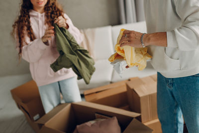 Midsection of woman holding box