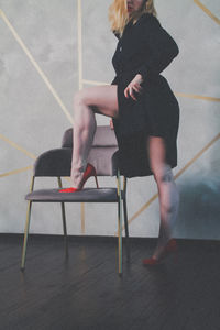 Side view of woman sitting on tiled floor