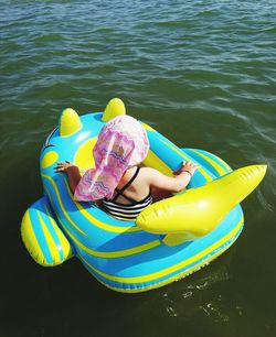 High angle view of girl in inflatable boat on lake