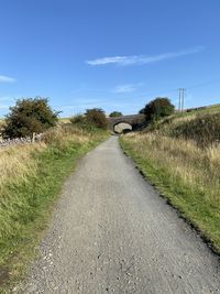 Empty road along countryside landscape