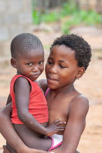 Portrait of boy with mother and daughter outdoors