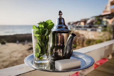 Traditional moroccan tea pot with a cup outside ready to drink