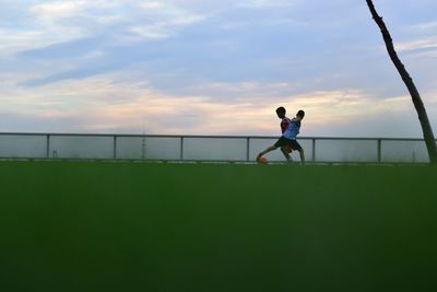 Silhouette of people walking on beach
