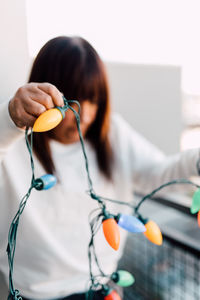 Woman holding colorful lighting equipment