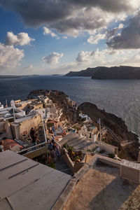 High angle view of townscape by sea against sky