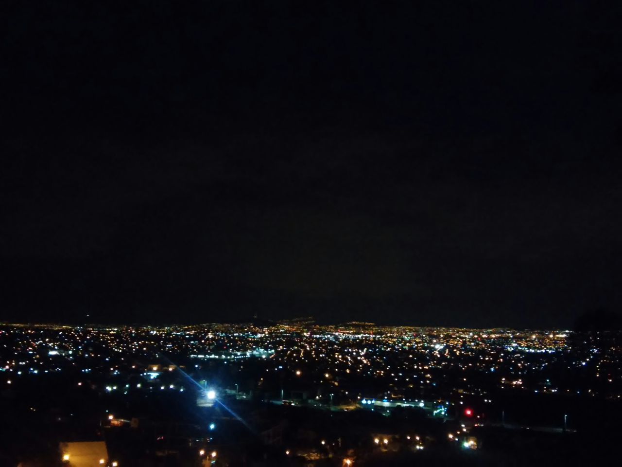 night, illuminated, cityscape, city, crowded, dark, copy space, high angle view, building exterior, aerial view, architecture, built structure, sky, clear sky, residential district, city life, light, no people, outdoors, landscape