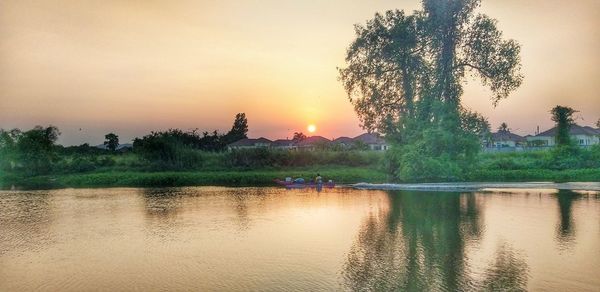 Scenic view of lake against sky during sunset