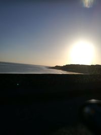 Scenic view of sea against clear sky during sunset