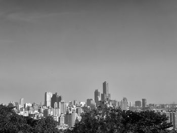 Modern buildings in city against clear sky