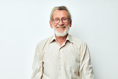 Portrait of young man standing against white background