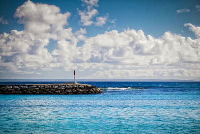 Scenic view of sea against cloudy sky