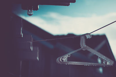 Close-up of clothes hanging against sky