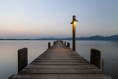 Wooden jetty on pier at sea against sky