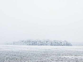 Scenic view of frozen field against clear sky